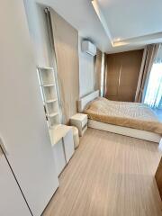 Modern bedroom with wooden flooring and beige design elements
