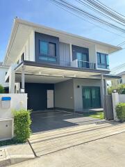 Two-story modern house exterior with a carport