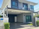 Two-story modern house exterior with a carport