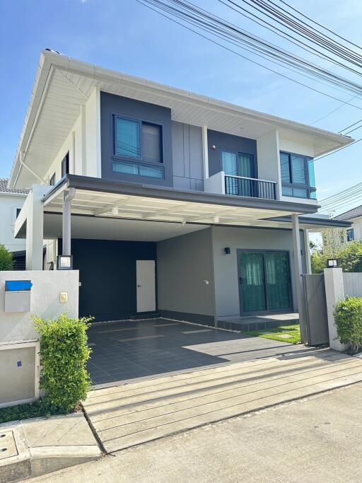 Two-story modern house exterior with a carport