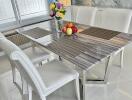 Elegant dining area with a marble table and white chairs