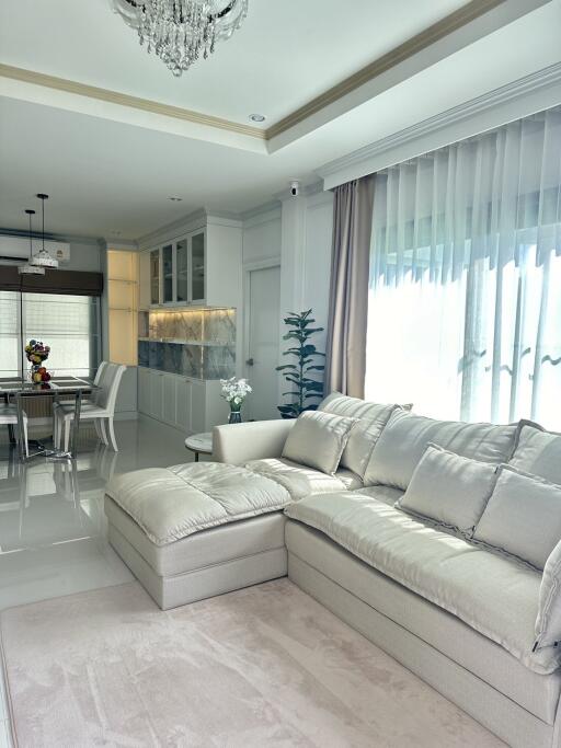 Modern living room with sectional sofa and view into dining area