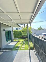 Covered patio with view of garden and driveway