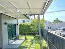 Covered patio with view of garden and driveway