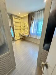 Bedroom with vanity desk and window