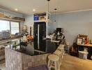 Modern kitchen with black countertop and bar stools