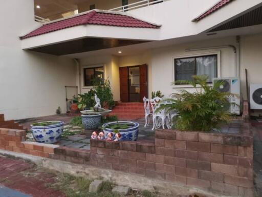 Outdoor view of a residential home with plants and seating