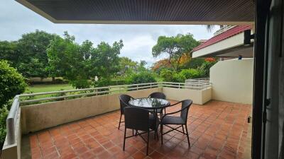 Spacious balcony with outdoor furniture and garden view