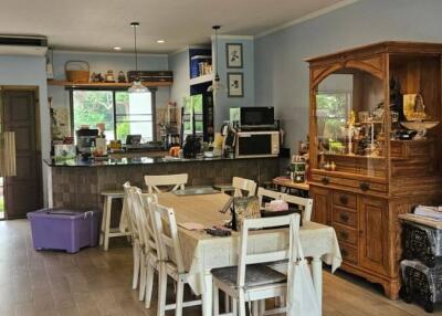 Open kitchen and dining area with wooden cabinets and appliances