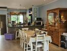 Open kitchen and dining area with wooden cabinets and appliances