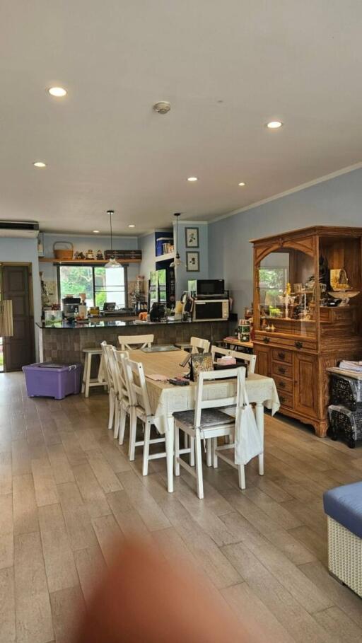 Open kitchen and dining area with wooden cabinets and appliances