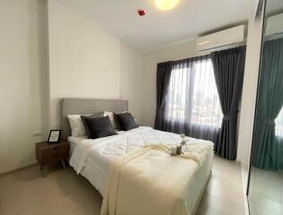 Modern bedroom with large windows and contemporary furnishings