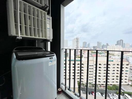 Balcony view with washing machine and cityscape