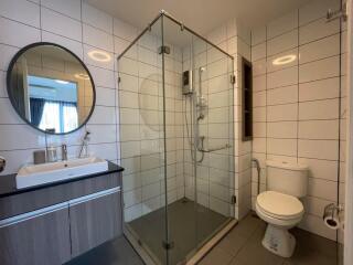 Modern bathroom with glass shower and large mirror