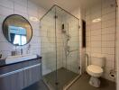 Modern bathroom with glass shower and large mirror