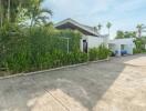 Exterior of a house with a driveway and greenery