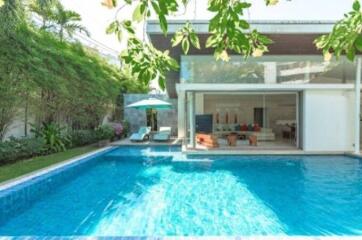 Modern house with swimming pool and poolside lounge area