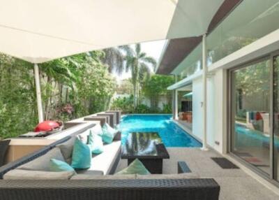 Outdoor seating area with poolside view