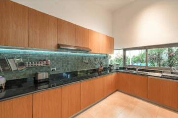 Modern kitchen with wooden cabinets and black countertops