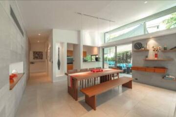 Modern dining area with wooden table and benches