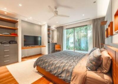 Spacious bedroom with modern furnishings and garden view