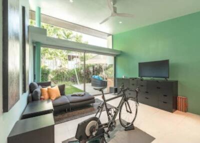 Modern bright living room with a bicycle and TV