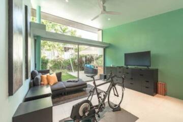 Modern bright living room with a bicycle and TV