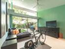 Modern bright living room with a bicycle and TV