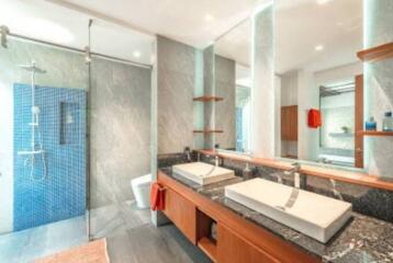 Modern bathroom with double sink and glass shower