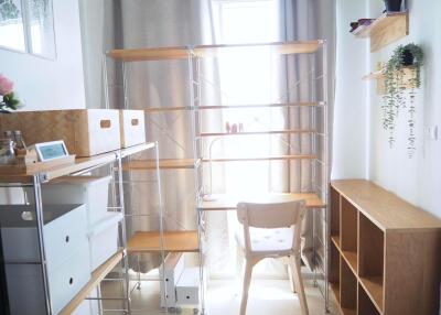 Bright and organized home office with shelving units and a desk