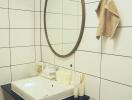 Modern bathroom with white tiles and oval mirror