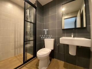 Modern bathroom with attached shower, toilet, and sink