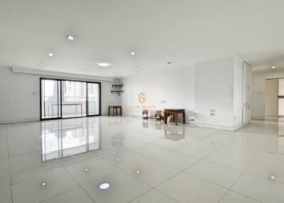 Spacious living area with large windows and polished floors