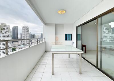 Spacious balcony with city view and sliding glass doors