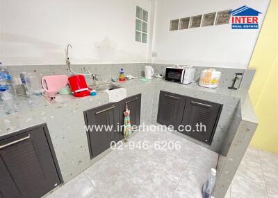 Modern kitchen area with appliances and cooking essentials