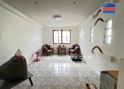 Spacious living room with tiled floor and large window