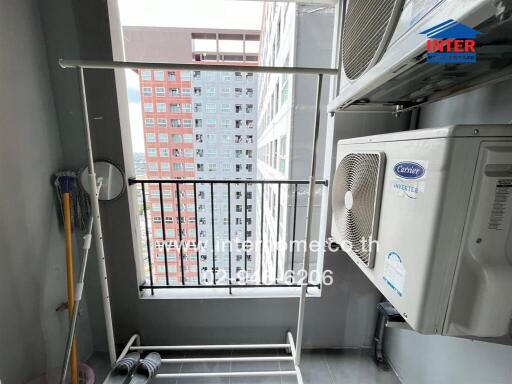 Balcony with city view and air conditioning units