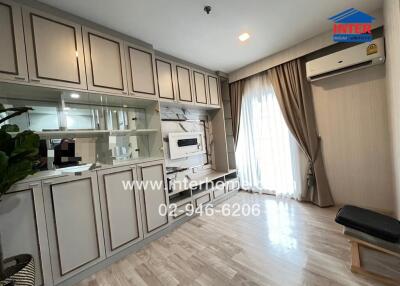 Living room with built-in wall unit and large window