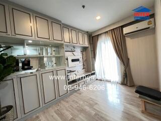 Living room with built-in wall unit and large window