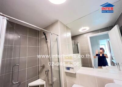Modern bathroom with shower area and large mirror
