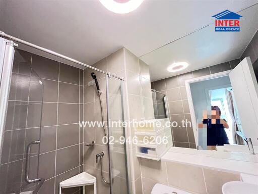 Modern bathroom with shower area and large mirror