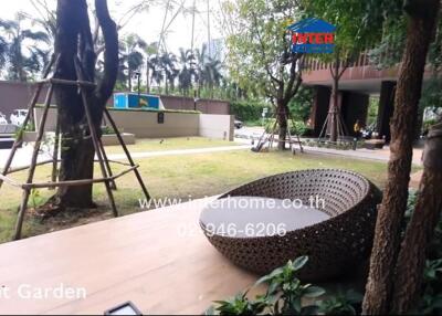 Front garden with a modern wicker seating area and surrounding greenery