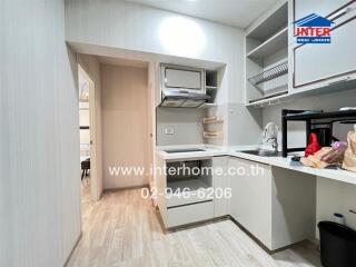 Modern kitchen with light wood flooring and white cabinetry