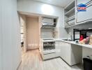 Modern kitchen with light wood flooring and white cabinetry