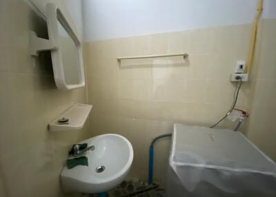 Small bathroom with sink and washing machine