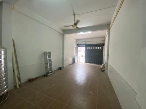 Spacious garage with tiled floor and ceiling fan