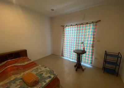 Bedroom with bed, window, and furniture