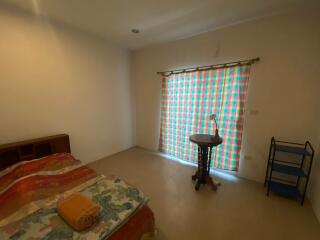 Bedroom with bed, window, and furniture