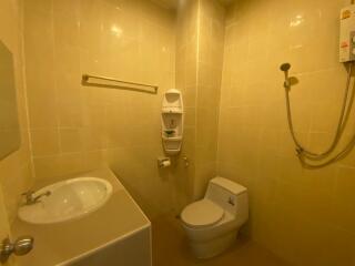 A clean and well-lit bathroom with a sink, toilet, and shower