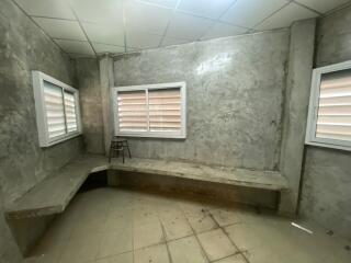 Unfinished room with concrete walls and minimal furnishing